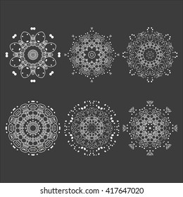 Mandala set. White mandalas on the black background