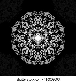 Mandala. Silver round ornament pattern on black background.