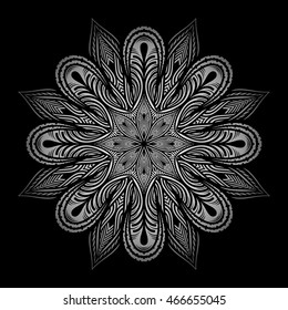 Mandala. Silver round ornament pattern on black background.