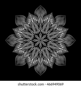 Mandala. Silver round ornament pattern on black background.