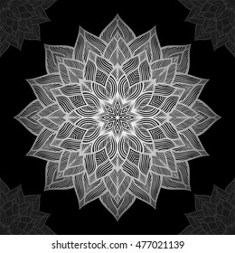 Mandala. Silver round ornament pattern on black background. 