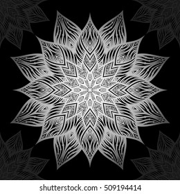 Mandala. Diseño de adorno redondo plateado sobre fondo negro.