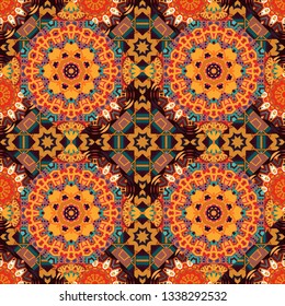 Mandala vector element. Colorful flower seamless pattern. Stylized floral motif in yellow, red and orange colors. Round ornament decoration.