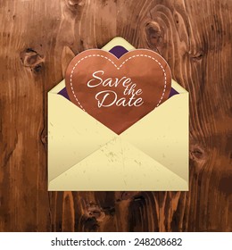 Manila envelope with a heart on a wooden background. In the style of handmade. For your postcards, greetings and invitations