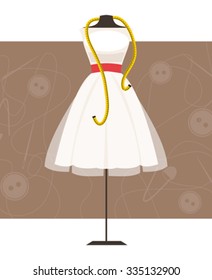 Mannequin with dress and centimeter on sewing background