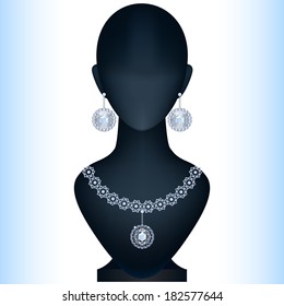 Mannequin with women's jewelery. Silver earrings and necklace with topaz