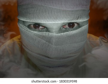 Man's face blindfolded with a sinister look and mist for a Halloween theme