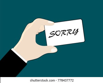 
A man's hand (businessman) holds a card with words "sorry"