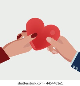 Mans hand giving woman's hand a heart.