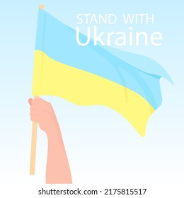 Man's hand holds the flag of Ukraine in support of the country