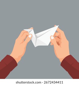 As mãos de um homem dobram cuidadosamente um pedaço de papel em um simples pássaro origami.