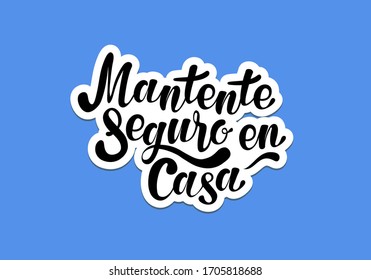 Mantente sequre en casa (Stay safe at home in spanish). Poster for print and stamps. Message isolated on blue background.