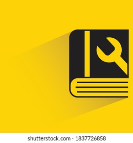 manual book with drop shadow on yellow background