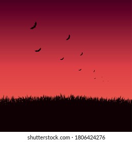 Many bats on a bright red sunset