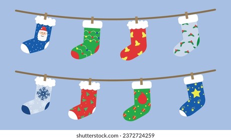 Many beautiful Christmas socks hanging on rope against color bac