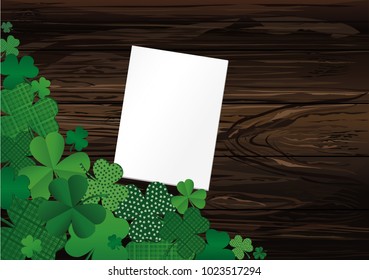 Many breeds of clover on the table. Empty blank sheet for advertising or text. Greeting card for St. Patrick's Day celebration. Vector illustration on a  wooden background