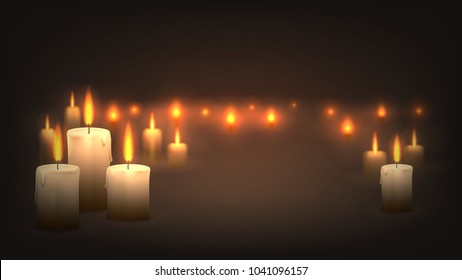 Many candles burn in the dark