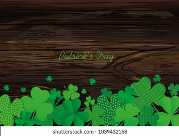 Many decorative clover. A pile of multicolored trelistnikov are on the table.St.Patrick 's Day. Vector illustration. Greeting card with empty space for text or advertising. On a wooden background.