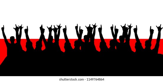 many fans actively hold their hands high on a colored background