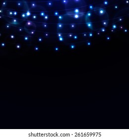 Many glowing blue lights on strings, background with garlands and place for text