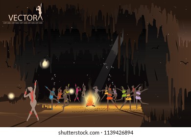 many people dancing around campfire on cave background