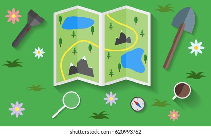 Map of the area and tourist things on the grass.