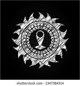 map pointer icon inside chalk emblem