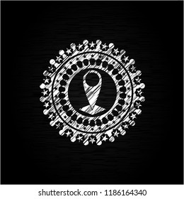 map pointer icon inside chalkboard emblem on black board