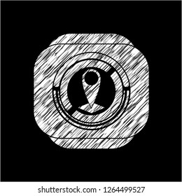 map pointer icon inside chalkboard emblem written on a blackboard