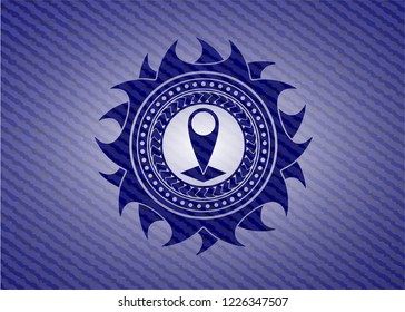 map pointer icon inside emblem with denim texture