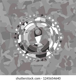 map pointer icon inside grey camouflage emblem
