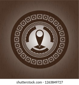 map pointer icon inside wood badge or emblem