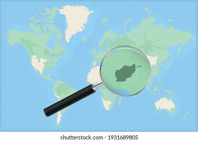 Map of the world with a magnifying glass on a map of Afghanistan Detailed map of Afghanistan and neighboring countries in the magnifying glass.