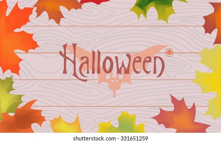 Maple color fall leaves, pumpkin, bat, halloween inscription in the center on wooden planks background