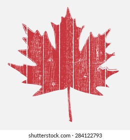 Maple leaf painted on a wooden planks for your design. EPS10 vector. 