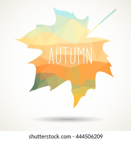 Maple leaf in triangular style with hand drawn word 'Autumn'.