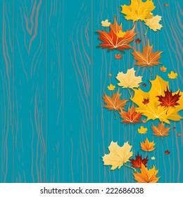 Maple leaves on wood background with place for text.