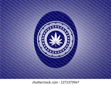 marijuana leaf icon inside badge with denim background