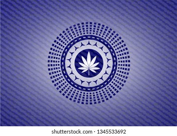 marijuana leaf icon inside badge with denim background