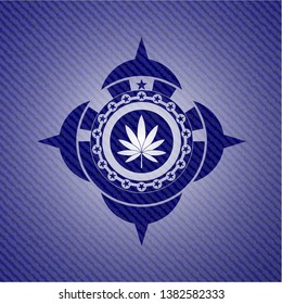 marijuana leaf icon inside badge with denim background