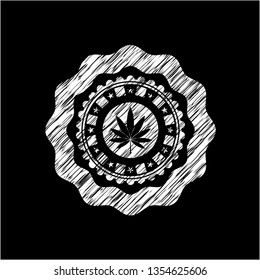 marijuana leaf icon inside chalk emblem written on a blackboard