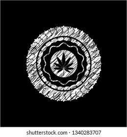 marijuana leaf icon inside chalkboard emblem on black board