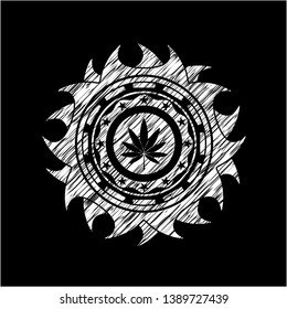 marijuana leaf icon inside chalkboard emblem on black board