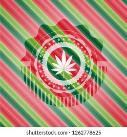 marijuana leaf icon inside christmas colors badge.