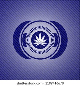 marijuana leaf icon inside emblem with jean background