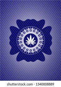 marijuana leaf icon inside emblem with denim texture