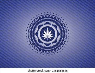 marijuana leaf icon inside emblem with jean background
