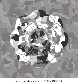 marijuana leaf icon inside grey camouflage emblem