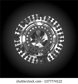 marijuana leaf icon inside grey camouflaged emblem