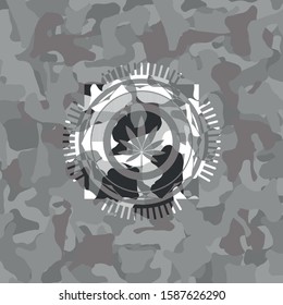 marijuana leaf icon inside grey camouflaged emblem
